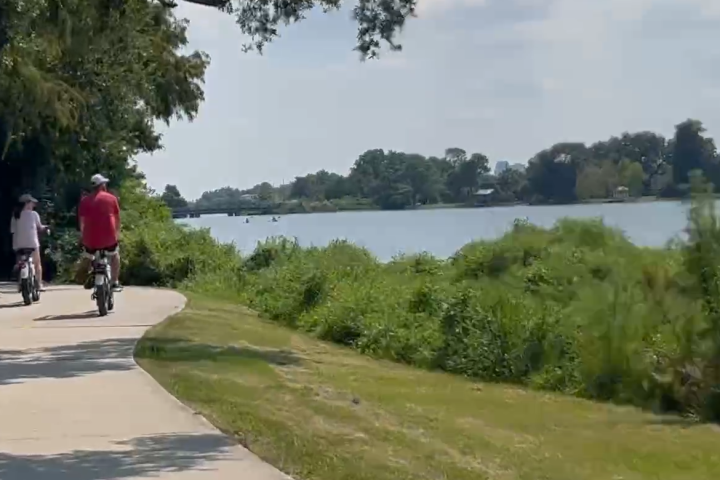 a person riding a skateboard down the side of a road